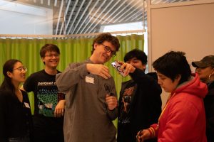 High school students look at holograms.